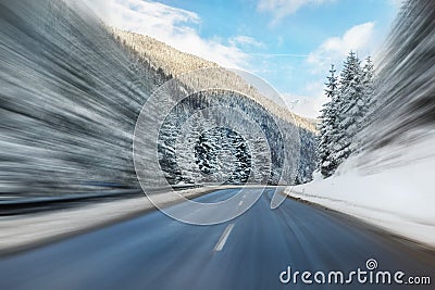 Winter alpine road curve landscape with forest, mountains and blue sky on background at bright cold sunny day. Car trip family Stock Photo