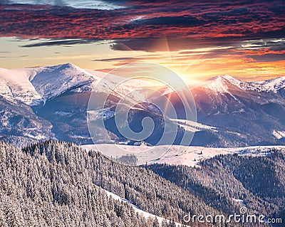 Winter alpine sunrise in mountains with dramatic sky Stock Photo