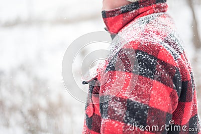 Winter background with snow covered man in red jacket Stock Photo