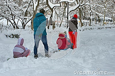 Winter landscape. Winter with snow in Bucharest, Romania. Family in the park Editorial Stock Photo