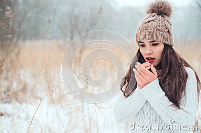winter close up portrait of beautiful young woman in knitted hat and sweater walking outdoor Stock Photo