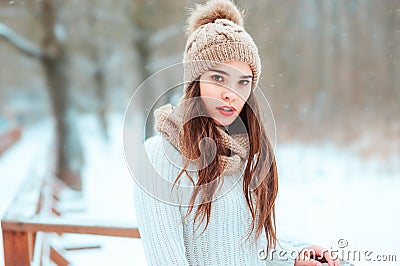 Close up winter portrait of dreamy young woman walking in snowy forest Stock Photo