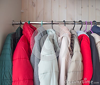 Winter clothes in a closet on a coat hanger. cleaning winter clothes until next season Stock Photo