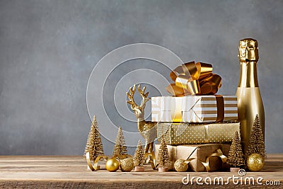 Winter composition with Christmas gift or present boxes and golden holiday decorations on wooden background. Greeting card. Stock Photo