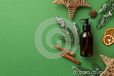 Winter cosmetics concept. Top view photo of amber glass bottle spruce branches in hoarfrost christmas decor wicker stars anise Stock Photo