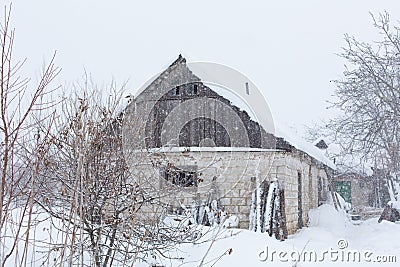 Winter countryside landscape, dilapidated abandoned ruined building covered in snow Stock Photo