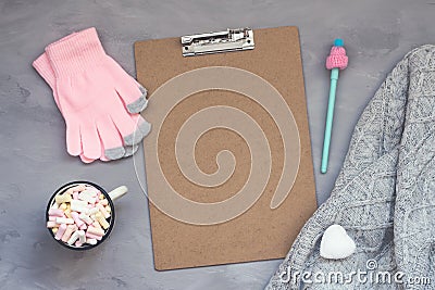 Winter cozy clipping board mockup, banner. Coffee with marshmallows, knitted sweater, white heart, pen with cap and pink gloves on Stock Photo