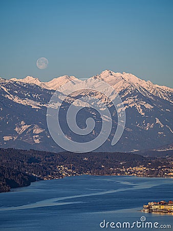 Winter dawn landscape over the Millstatter See in Carinthia, Austria, full moon Stock Photo