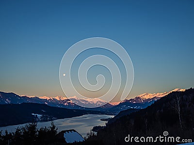 Winter dawn landscape over the Millstatter See in Carinthia, Austria, full moon Stock Photo