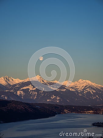 Winter dawn landscape over the Millstatter See in Carinthia, Austria, full moon Stock Photo