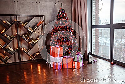 Winter decoration. decoration of the shelf for the new year or Christmas. candles, Christmas tree, books, bows and bumps Stock Photo