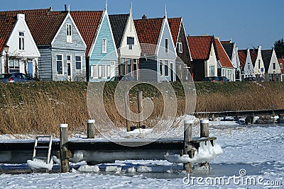 Winter in Durgerdam with frozen pond and colourful wooden houses Stock Photo