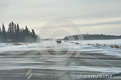 Blowing snow across the highway Stock Photo