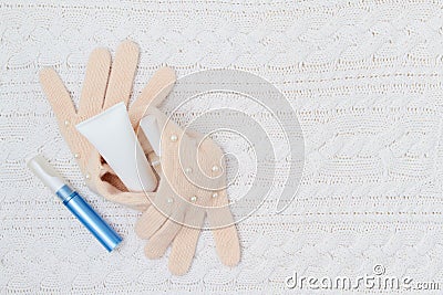 Winter flat lay with hand cream, nail polish and gloves Stock Photo