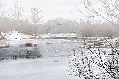 The winter fog over the river. Thawing in the ice of river Stock Photo