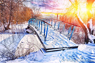 Winter frosty trees and old snowy bridge in the winter park Stock Photo