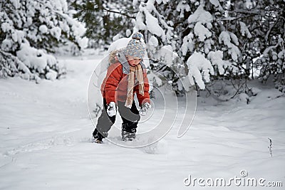 Winter fun. the boy sculpts the snowman. Stock Photo