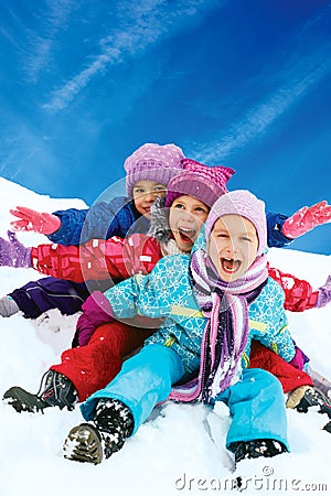 Winter fun, snow, children sledding at winter time Stock Photo