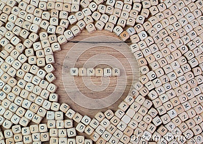 Winter, German text for winter, word in letters on cube dices on table Stock Photo