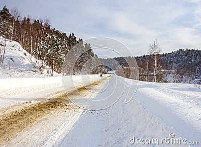 Winter in the highlands, walking on a snow-covered road, panoramic views and relaxing in the mountains. Stock Photo