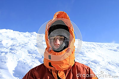 Winter hiking in the mountains on snowshoes with a backpack and tent. Stock Photo