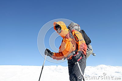 Winter hiking in the mountains on snowshoes with a backpack and tent. Stock Photo