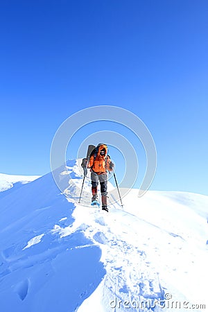 Winter hiking in the mountains on snowshoes with a backpack and tent. Stock Photo