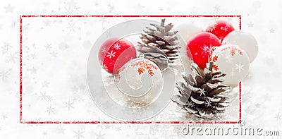 Winter holiday backdrop with snowflakes, fir cones and red white Christmas balls Stock Photo