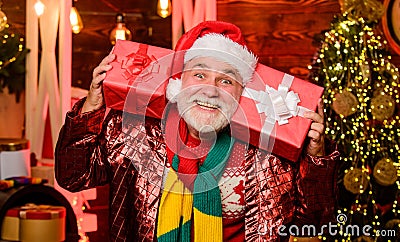 Winter holiday celebration. Garland lights cozy atmosphere. New year celebration. Senior man Santa claus. Boxing day Stock Photo