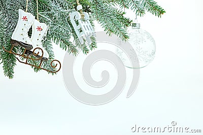 Winter holiday decoration with christmas tree branch, decorative skates, sledges toys and transparent glass ball Stock Photo