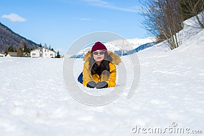 Winter holiday trip to snow valley - young happy and excited Asian Chinese woman playful on frozen lake in snowy mountains at Stock Photo