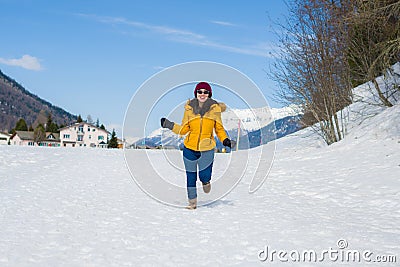 Winter holiday trip to snow valley - young happy and excited Asian Japanese woman playful on frozen lake in snowy mountains at Stock Photo