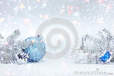 Winter holidays composition on white snow with christmas tree branches, decorative blue ball, silver glass star and drums toy Stock Photo