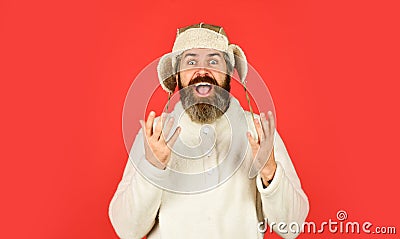 Winter holidays. Male winter style. Modern winter earflap beanie hat. Funky happy bearded man. mature man posing with Stock Photo