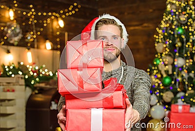Winter holidays. Shopping concept. How to Choose Perfect Gift. Man Santa claus with gift box. Handsome guy celebrate Stock Photo