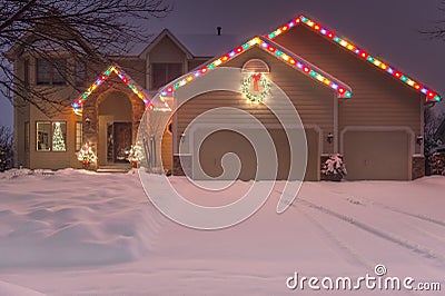 Winter Home with Holiday Lights and Tracks Stock Photo