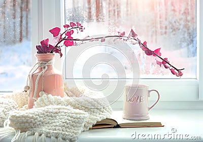 Winter home romantic icon.Valentine card.Mug with knits and book on window sill Stock Photo