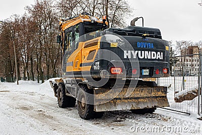 Winter Hyundai wheel excavator with bucket of sand Editorial Stock Photo