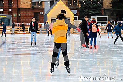 Winter ice rink. Happy boys have fun on ice. Active family sport during Christmas winter break. School sports clubs. Dnipro city Editorial Stock Photo