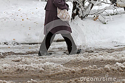 Winter. Ice. Snow. People walks a snowy icy road passing snowy cars on uncleaned icy street after a heavy snowfall. Unclea Stock Photo