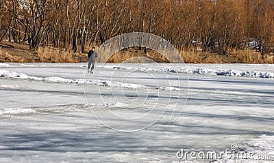 On a winter lake, people skate on skates. Winter sunny landscape Editorial Stock Photo