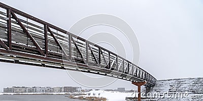 Winter lake scene with snowy bridge in Daybreak Stock Photo