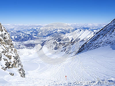 Winter landscape with free ride piste and view on snow covered slopes and blue sky, with Aerial view of Zell am See lake Stock Photo