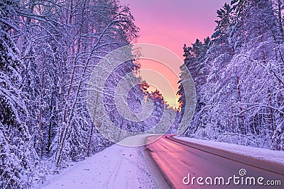 Winter landscape with sunset,road and forest Stock Photo