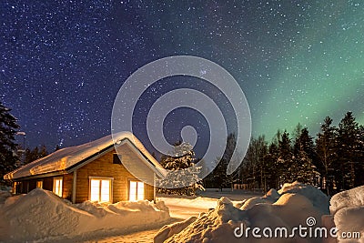 Winter landscape with wooden house under a beautiful starry sky Stock Photo