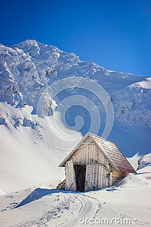 Winter landscape with wooden toolshed at Balea lake, Sibiu county, Romania. Stock Photo