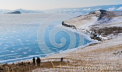 Winter landscape, tourist trekking on the island at frozen lake Baikal in Siberia, Russia Stock Photo