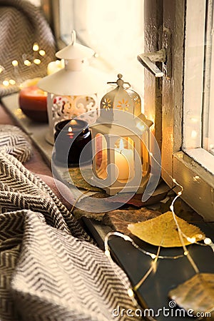Winter lanterns decorations at window,cosy home interior decoration with candles Stock Photo