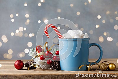 Winter lifestyle with cup of hot cocoa with marshmallows and Christmas decoration on wooden background. Bokeh effect Stock Photo