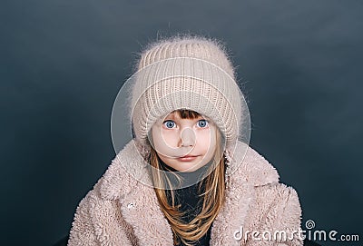 Winter little girl cold freeze gesture expression with fur clothes fashion and cap Stock Photo